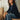 Femme assise sur un banc portant le top Joao nuit en micromodal, manches 3/4, avec un jean large – yvo et moi