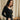Sous-pull chaud femme en laine et soie Owen noir porté avec un jean noir, devant un rideau en lin et bouquet de fleurs – yvo et moi